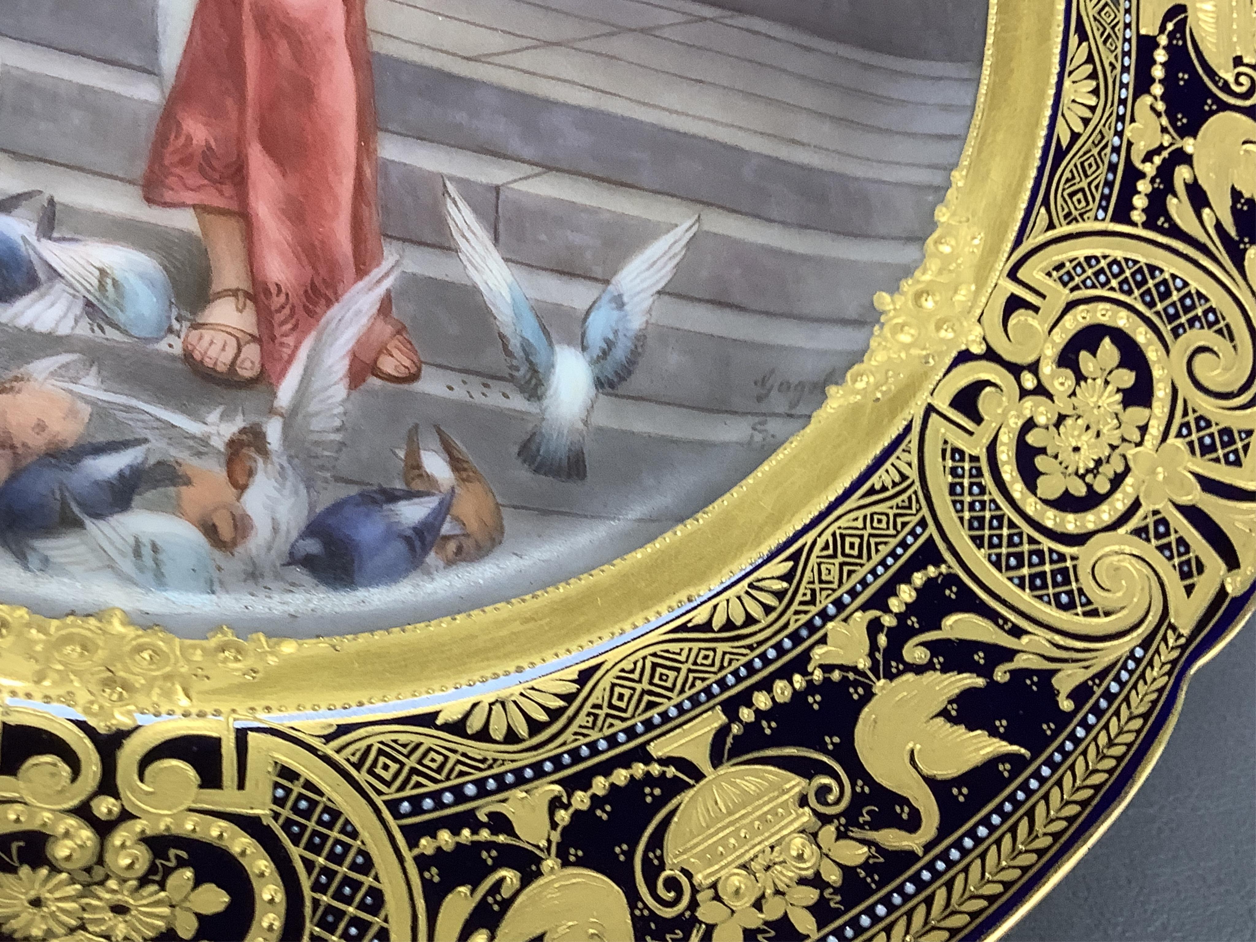 A Vienna-style cabinet plate, painted with a Vestal Virgin, after P. Wagner, depicting a lady feeding pigeons, signed Goget?, 24cm in diameter
